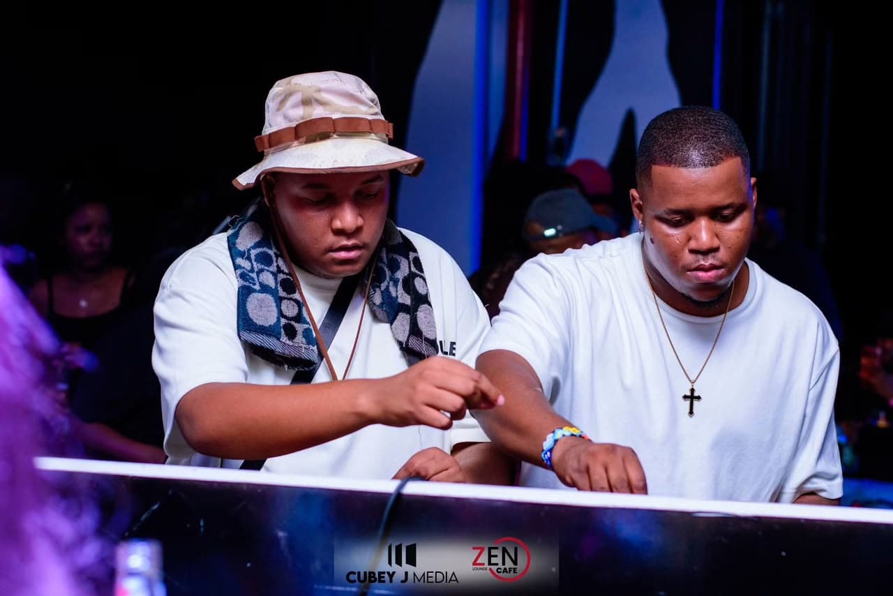 Two DJs work the decks together at the Zen DJ booth.